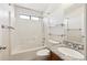 Bright bathroom featuring tile, a shower-tub combo, and a granite topped vanity at 13416 S 47Th St, Phoenix, AZ 85044
