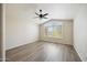 Bedroom with wood floors, large window, and neutral walls at 13416 S 47Th St, Phoenix, AZ 85044