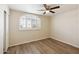 Bedroom boasts modern flooring, arched window with shutters, and ample lighting at 13416 S 47Th St, Phoenix, AZ 85044