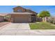 Inviting home with a two-car garage, manicured lawn, and attractive desert landscaping at 13416 S 47Th St, Phoenix, AZ 85044