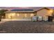 Backyard featuring gravel landscaping, patio, and solar panels on the house roof at 136 N 236Th Ave, Buckeye, AZ 85396