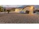 Home with a spacious, gravel backyard and solar panels, perfect for outdoor living and sustainability at 136 N 236Th Ave, Buckeye, AZ 85396