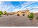 Backyard with a gravel landscape design, featuring solar panels for energy efficiency and low maintenance at 136 N 236Th Ave, Buckeye, AZ 85396
