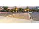 Outdoor living area with paved patio, desert landscaping, and atmospheric lighting at 136 N 236Th Ave, Buckeye, AZ 85396