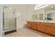 Bright bathroom with walk-in shower, bathtub, tile floor, and double sink vanity at 136 N 236Th Ave, Buckeye, AZ 85396