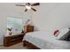Cozy bedroom with neutral tones, a ceiling fan, and natural light from the window at 136 N 236Th Ave, Buckeye, AZ 85396