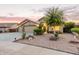 Charming single-story home featuring a three-car garage and a well-maintained, xeriscaped front yard at 136 N 236Th Ave, Buckeye, AZ 85396