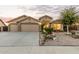 Charming single-story home featuring a three-car garage and a well-maintained, xeriscaped front yard at 136 N 236Th Ave, Buckeye, AZ 85396