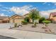 Charming single-story home featuring a three-car garage and a well-maintained, xeriscaped front yard at 136 N 236Th Ave, Buckeye, AZ 85396
