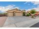 Charming single-story home featuring a three-car garage and a well-maintained, xeriscaped front yard at 136 N 236Th Ave, Buckeye, AZ 85396