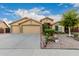 Charming single-story home featuring a three-car garage and a well-maintained, xeriscaped front yard at 136 N 236Th Ave, Buckeye, AZ 85396