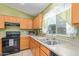 Traditional-style kitchen with stainless steel appliances, double sink, and light wood cabinetry at 136 N 236Th Ave, Buckeye, AZ 85396