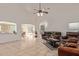 Open-concept living room with tile floors, vaulted ceilings, and easy access to the kitchen and dining areas at 136 N 236Th Ave, Buckeye, AZ 85396