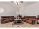 Comfortable living area features tile floors, vaulted ceilings and leather seating at 136 N 236Th Ave, Buckeye, AZ 85396