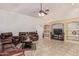 Spacious living room features vaulted ceilings, tile floors and custom built-in shelving at 136 N 236Th Ave, Buckeye, AZ 85396
