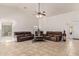 Bright living room with vaulted ceilings, tile flooring, and comfortable leather seating at 136 N 236Th Ave, Buckeye, AZ 85396