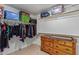 Walk-in closet offers ample storage space and features built-in shelves and drawers at 136 N 236Th Ave, Buckeye, AZ 85396