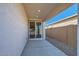Covered back patio overlooking the backyard with sliding glass doors leading into the home at 15760 W Pioneer St, Goodyear, AZ 85338