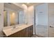 Elegant bathroom with a double sink vanity, large mirror, and access to bedroom at 15760 W Pioneer St, Goodyear, AZ 85338