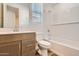 A well-lit bathroom featuring a vanity, toilet, and a bathtub with shower at 15760 W Pioneer St, Goodyear, AZ 85338