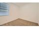 Comfortable bedroom featuring plush carpeting, a window, and neutral walls at 15760 W Pioneer St, Goodyear, AZ 85338