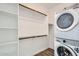 Convenient laundry room with washer, dryer, and built in storage shelves at 15760 W Pioneer St, Goodyear, AZ 85338