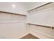 This walk-in closet features built-in shelving and hanging rods for optimal storage organization at 15760 W Pioneer St, Goodyear, AZ 85338