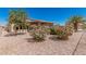 Beautiful backyard with desert landscaping and covered patio at 16115 W Acacia Ct, Surprise, AZ 85374