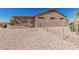 Fenced backyard with desert landscaping and covered patio at 16115 W Acacia Ct, Surprise, AZ 85374