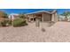Beautiful backyard featuring desert landscaping and a covered patio at 16115 W Acacia Ct, Surprise, AZ 85374