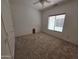 A carpeted bedroom with window, ceiling fan, and closet at 16115 W Acacia Ct, Surprise, AZ 85374