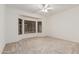 Bedroom featuring a bay window and neutral carpet with fan at 16115 W Acacia Ct, Surprise, AZ 85374