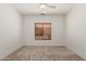 Bedroom featuring a window and neutral carpet with fan at 16115 W Acacia Ct, Surprise, AZ 85374