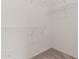 A simple walk-in closet with wire shelving and neutral carpet at 16115 W Acacia Ct, Surprise, AZ 85374