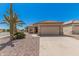 Desert home featuring rock landscaping, tile roof, and two-car garage at 16115 W Acacia Ct, Surprise, AZ 85374