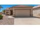 Single-story home featuring a two-car garage and low-maintenance desert landscaping at 16115 W Acacia Ct, Surprise, AZ 85374