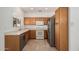 Kitchen features stainless steel appliances and light wood cabinets at 16115 W Acacia Ct, Surprise, AZ 85374
