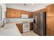 Kitchen featuring wood cabinets and stainless steel refrigerator at 16115 W Acacia Ct, Surprise, AZ 85374