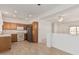 Open-concept kitchen with wood-look floors and stainless steel refrigerator at 16115 W Acacia Ct, Surprise, AZ 85374