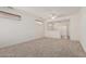 Living room featuring carpet flooring, ceiling fan and small windows at 16115 W Acacia Ct, Surprise, AZ 85374