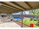 Inviting backyard with a pool, a covered patio, and an artificial grass area at 1620 N 72Nd Ln, Phoenix, AZ 85035