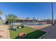 Backyard featuring a pool, artificial turf, and comfortable outdoor seating area at 1620 N 72Nd Ln, Phoenix, AZ 85035