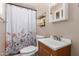 Bathroom features shower with curtain, a toilet, and a vanity at 1620 N 72Nd Ln, Phoenix, AZ 85035