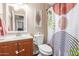 Bathroom features a vanity, a toilet, and a shower with a curtain at 1620 N 72Nd Ln, Phoenix, AZ 85035