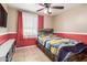 Bedroom features tile floors, a window, and a wood accent wall at 1620 N 72Nd Ln, Phoenix, AZ 85035