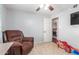 Bedroom with a recliner, tile floor and a view of the doorway to another room at 1620 N 72Nd Ln, Phoenix, AZ 85035