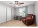 Cozy bedroom featuring a ceiling fan, a window with blinds and a recliner at 1620 N 72Nd Ln, Phoenix, AZ 85035