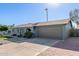 Charming single-story home features a well-manicured lawn, desert landscaping, and a two-car garage at 1620 N 72Nd Ln, Phoenix, AZ 85035