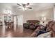 Inviting living room and dining area with wood flooring, a ceiling fan, and comfortable seating at 1620 N 72Nd Ln, Phoenix, AZ 85035