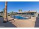 Backyard pool is surrounded by gravel and a safety fence for protection at 1620 N 72Nd Ln, Phoenix, AZ 85035